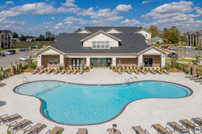 Springdale apartment for rent - A large house with a pool in front.