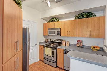 Phoenix apartment for rent - A kitchen with wooden cabinets and stainless steel appliances.