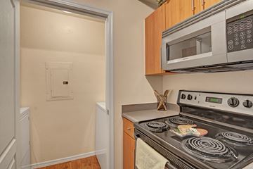 Phoenix apartment for rent - A kitchen with a stove, microwave, and oven.