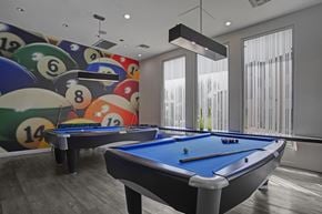 Phoenix apartment for rent - A pool table with a blue cloth and a wall with billiard balls.