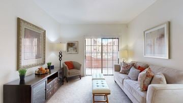 Phoenix apartment for rent - A living room with a couch, a chair, a coffee table, and a painting on the wall.