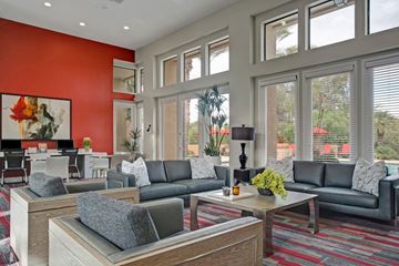 Phoenix apartment for rent - A living room with a grey couch and a red wall.