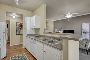 Phoenix apartment for rent - A kitchen with white cabinets and a stainless steel sink.