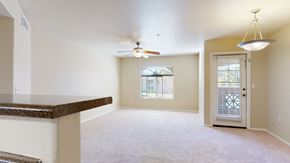 Glendale apartment for rent - A spacious room with a ceiling fan and a door leading to a balcony.