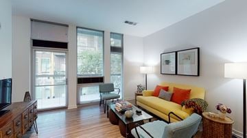 Phoenix apartment for rent - A living room with a yellow couch and a wooden coffee table.