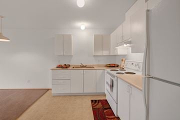 Grande Prairie apartment for rent - A kitchen with white cabinets and appliances.
