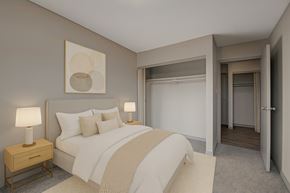 Edmonton apartment for rent - A cozy bedroom here at Cedar Gardens with soft neutral tones and a comfortable bed setup, featuring matching nightstands with warm lamps, simple wall art above the headboard, and a spacious closet area for an airy, relaxing feel.