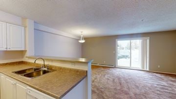 Calgary apartment for rent - A kitchen with a sink and a window.