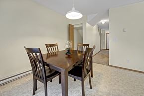 Fort St. John apartment for rent - A dining room with a wooden table and chairs.