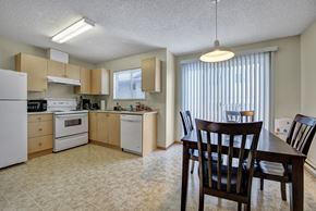Fort St. John apartment for rent - A kitchen with a table and chairs.