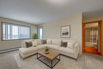 Stony Plain apartment for rent - A living room with a white couch and a coffee table.