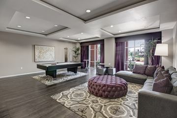 Corona apartment for rent - A modern living room with a pool table and a couch.