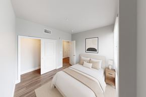 Sacramento apartment for rent - A bedroom with a large bed and a nightstand.