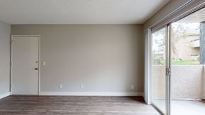 San Bernardino apartment for rent - A room with a white door and a window with a view of a building outside.
