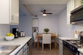 San Bernardino apartment for rent - A kitchen with a table and chairs in the middle.