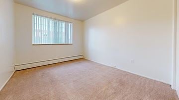 Colorado Springs apartment for rent - A room with a carpeted floor and a window with blinds.