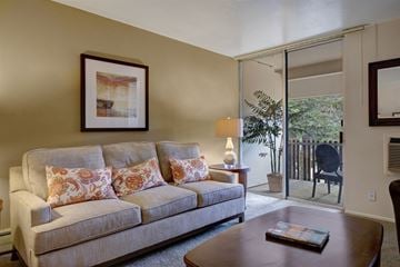 Colorado Springs apartment for rent - A living room with a couch, a coffee table, and a painting on the wall.