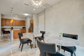 Colorado Springs apartment for rent - A modern dining room with a glass table and black chairs.
