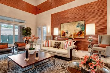 Colorado Springs apartment for rent - A living room with a leopard print rug and a painting on the wall.