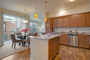 Colorado Springs apartment for rent - A kitchen with wooden cabinets and a white island.