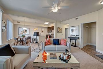 Colorado Springs apartment for rent - A living room with a white couch and a glass coffee table.