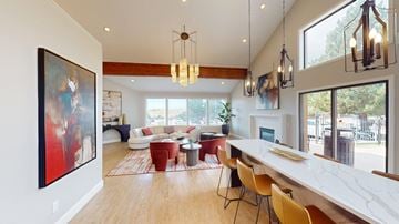 Colorado Springs apartment for rent - A modern living room with a long white table and chairs.