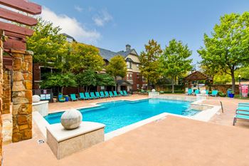 Resort-style swimming pool with waterfall