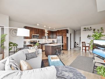 Minneapolis apartment for rent - A modern living room with a grey couch and a television.