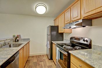 Stainless steel appliances in an open kitchen with plenty of cabinet storage