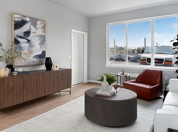 Wenatchee apartment for rent - A living room with a brown sofa, a red chair, a grey coffee table and a painting on the wall.