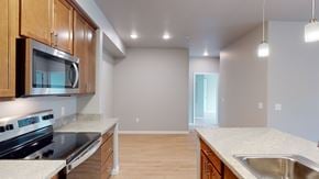 Wenatchee apartment for rent - A kitchen with wooden cabinets and a stainless steel stove top oven.