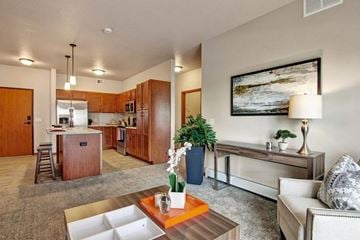 Sartell apartment for rent - A living room with a couch, a coffee table, and a painting on the wall.