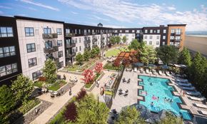 St. Paul apartment for rent - A landscaped outdoor courtyard here at Collection at Highland Bridge featuring a resort-style swimming pool with lounge seating, shaded umbrellas, and people enjoying the water, surrounded by walking paths, manicured greenery, outdoor dining areas, and modern apartment buildings with balconies under a bright blue sky.