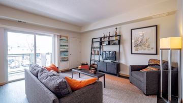 Hopkins apartment for rent - A living room with a grey couch and a coffee table.
