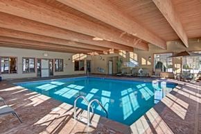 St. Cloud apartment for rent - A large indoor swimming pool with sunlight streaming in through the windows.