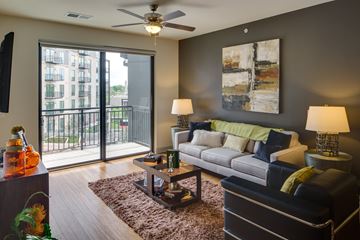 Minneapolis apartment for rent - A living room with a couch, two lamps, and a painting on the wall.