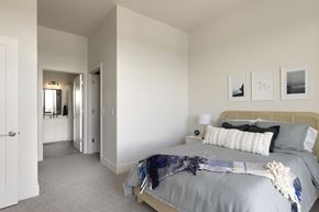 Minneapolis apartment for rent - A modern living room with a grey sofa and a kitchen area in the background.