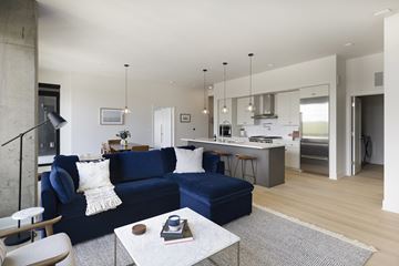 Minneapolis apartment for rent - A modern living room with a blue sofa and a coffee table.