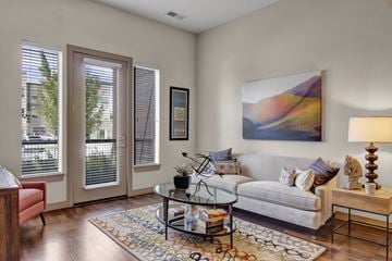 Ramsey apartment for rent - A living room with a couch, a coffee table, and a painting on the wall.
