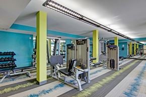 Bloomington apartment for rent - A gym with a variety of equipment including weights and weight machines.