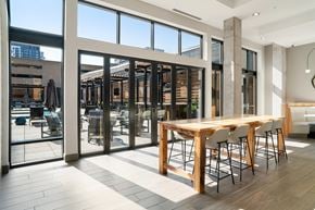 Minneapolis apartment for rent - A modern dining room with a long wooden table and chairs.