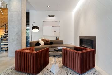 Minneapolis apartment for rent - A living room with a grey couch and a fireplace.