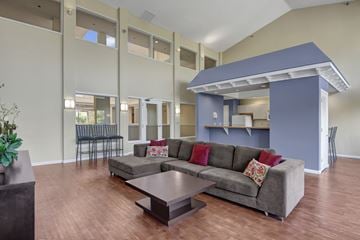 Eagan apartment for rent - A living room with a grey couch and a wooden coffee table.