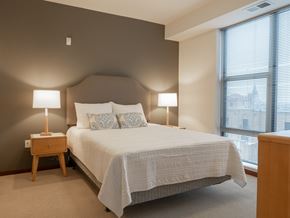 Minneapolis apartment for rent - A kitchen with dark wood cabinets and a black refrigerator.
