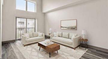 Charlotte apartment for rent - A living room with two couches, a coffee table, and a painting on the wall.
