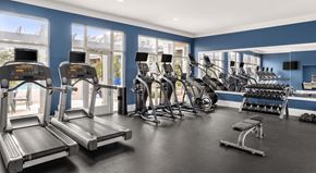 Charlotte apartment for rent - A gym with treadmills, exercise bikes, and dumbbells.