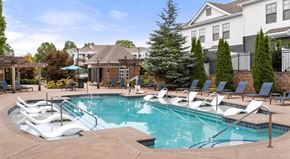 Charlotte apartment for rent - A pool with a slide and chairs around it.