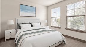Charlotte apartment for rent - A bedroom with a large bed, a nightstand, and a window with blinds.