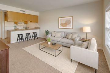 Williston apartment for rent - A living room with a white couch, a coffee table, and a painting on the wall.