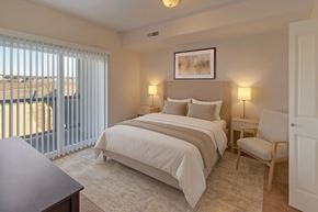 Williston apartment for rent - A bedroom with a large bed and a chair.
